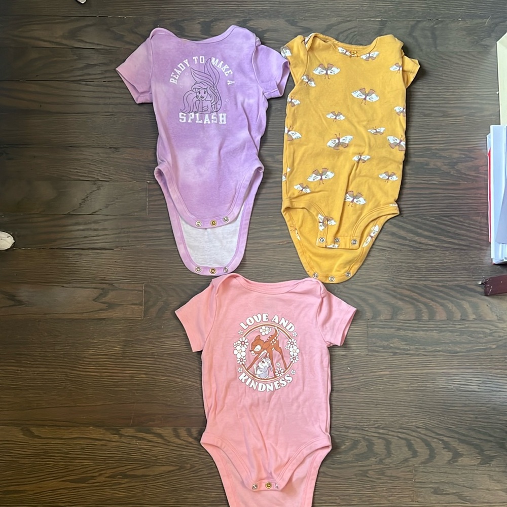 Gently used 3 nine month girl onesies. to our Disney brand and one is Carter’s.